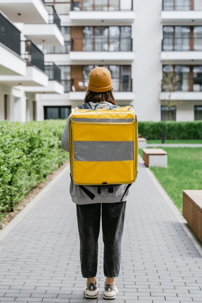 Deliveryman Carrying a Yellow Bag